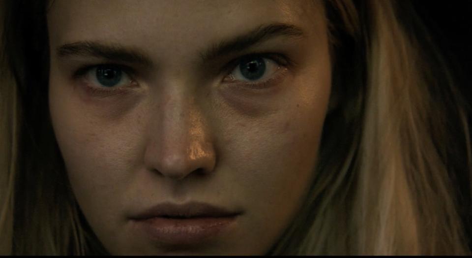 Close-up of Sasha Luss's intense expression in Latency