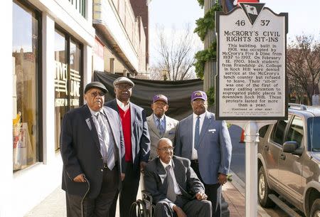 Friendship Nine members Clarence Graham, David Williamson Jr., Willie Thomas Massey, James F. Wells and Willie E. McCleod (L-R) stand in front of a historical commemorative marker outside the Five & Dine diner in Rock Hill, South Carolina, December 17, 2014. REUTERS/Jason Miczek