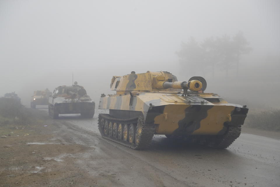 Armenian self-propelled artillery units roll on a road during the withdrawal of Armenian troops from the separatist region of Nagorno-Karabakh, Wednesday, Nov. 18, 2020. A Russia-brokered cease-fire to halt six weeks of fighting over Nagorno-Karabakh stipulated that Armenia turn over control of some areas it holds outside the separatist territory's borders to Azerbaijan. Armenians are forced to leave their homes before the region is handed over to control by Azerbaijani forces. (AP Photo/Sergei Grits)