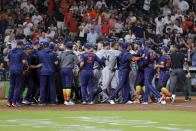 Both dugouts empty and umpires try to keep order after Seattle Mariners batter Ty France was hit by a pitch from Houston Astros relief pitcher Hector Neris during the ninth inning of a baseball game Monday, June 6, 2022, in Houston. (AP Photo/Michael Wyke)