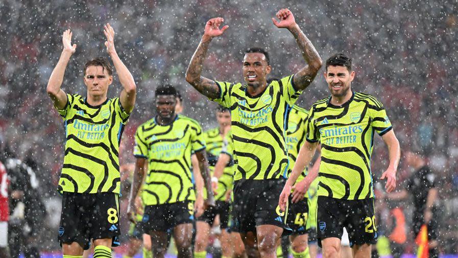 Arsenal players celebrate their win against Manchester United