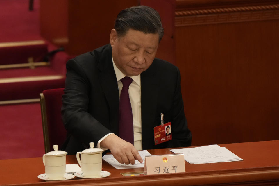 Chinese President Xi Jinping presses a button to vote during a session of China's National People's Congress (NPC) at the Great Hall of the People in Beijing, Friday, March 10, 2023. (AP Photo/Mark Schiefelbein)