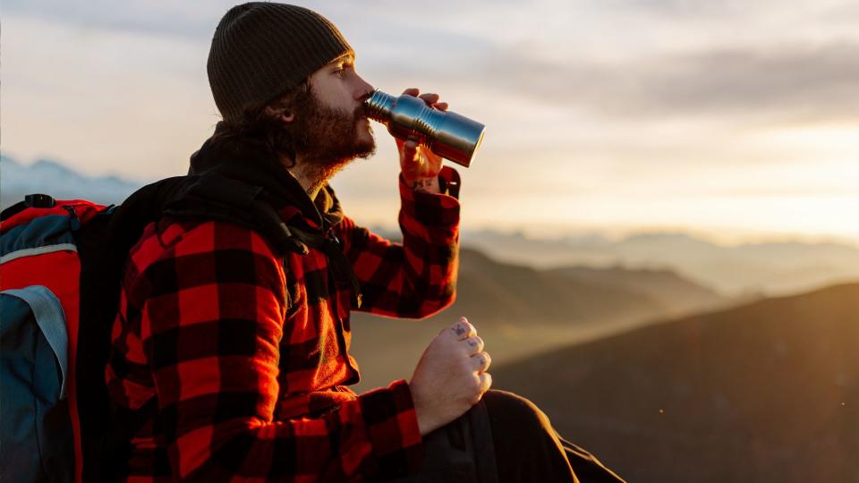 Man drinking water out of a bottle