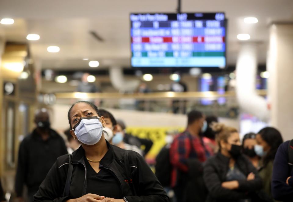 Commuters wait to see what track their homebound NJ Transit train will be leaving from during rush hour at Penn Station Nov. 9, 2020. The COVID-19 pandemic has caused the number of commuters to decrease to a fraction of those who used the terminal prior to the pandemic.