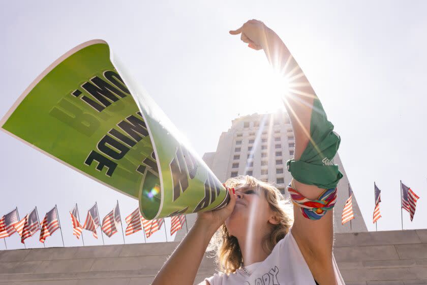 Tayler Holcomb chants along with pro-choice protesters outside of City Hall in July