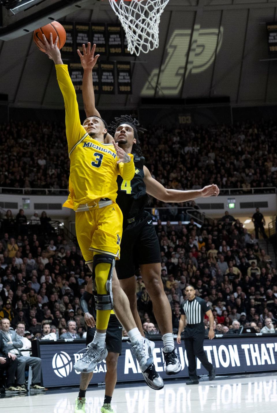 Michigan guard Jaelin Llewellyn shoots the ball in front of Purdue forward Trey Kaufman-Renn during the first half on Tuesday, Jan. 23, 2024, in West Lafayette, Indiana.