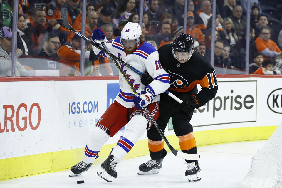 Philadelphia Flyers' Tyler Pitlick, right, and New York Rangers' Marc Staal battle for the puck during the second period of an NHL hockey game, Friday, Feb. 28, 2020, in Philadelphia. (AP Photo/Matt Slocum)