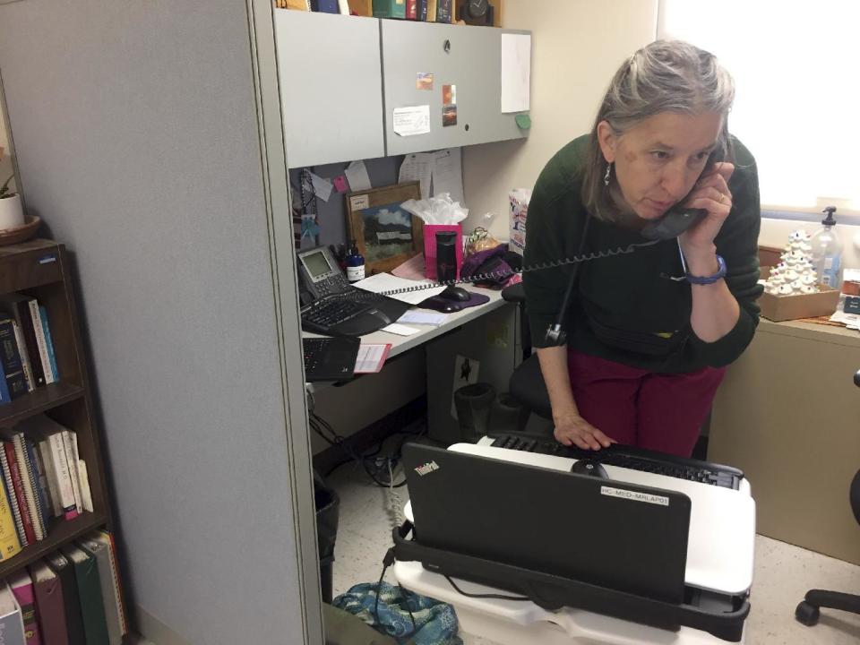 In this Dec. 21, 2016 photo, family physician Leslie Hayes begins her workday at the El Centro Family Health medical clinic in Espanola, N.M. Hayes credits her ability to effectively treat opioid addiction disorders to a training and mentoring program known as Project ECHO that is being tapped by federal officials for possible broader applications. (AP Photo/Morgan Lee)