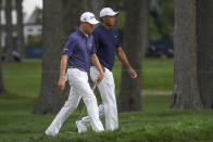 Justin Thomas, of the United States, left, and Tiger Woods, of the United States, walk up to the seventh green during the first round of the US Open Golf Championship, Thursday, Sept. 17, 2020, in Mamaroneck, N.Y. (AP Photo/John Minchillo)