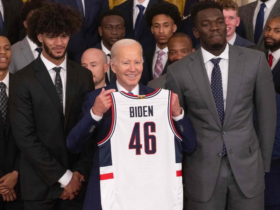President Joe Biden holds a jersey given by the University of Connecticut Huskies men's basketball team during a celebration for their 2022-2023 NCAA Championship season at the White House in Washington, DC, on May 26, 2023.