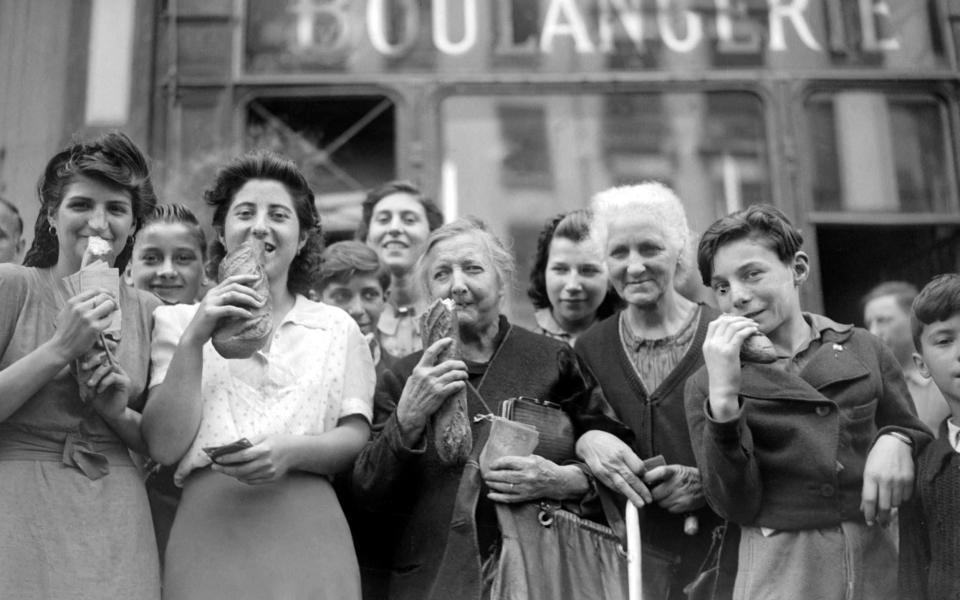 Parisians buying bread after years of living of on rations in 1944 - STF