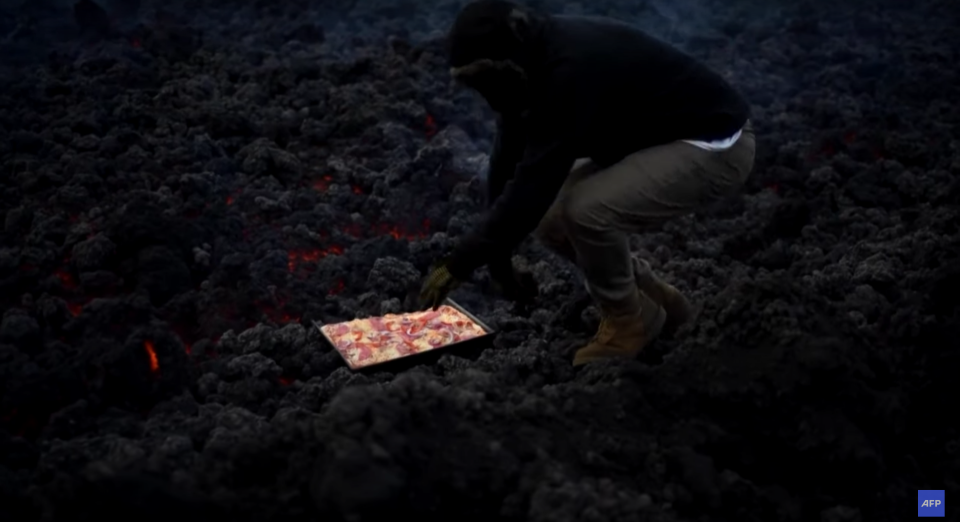 Guatemalan chef David Garcia stands over lava and cooks a square pepperoni pizza