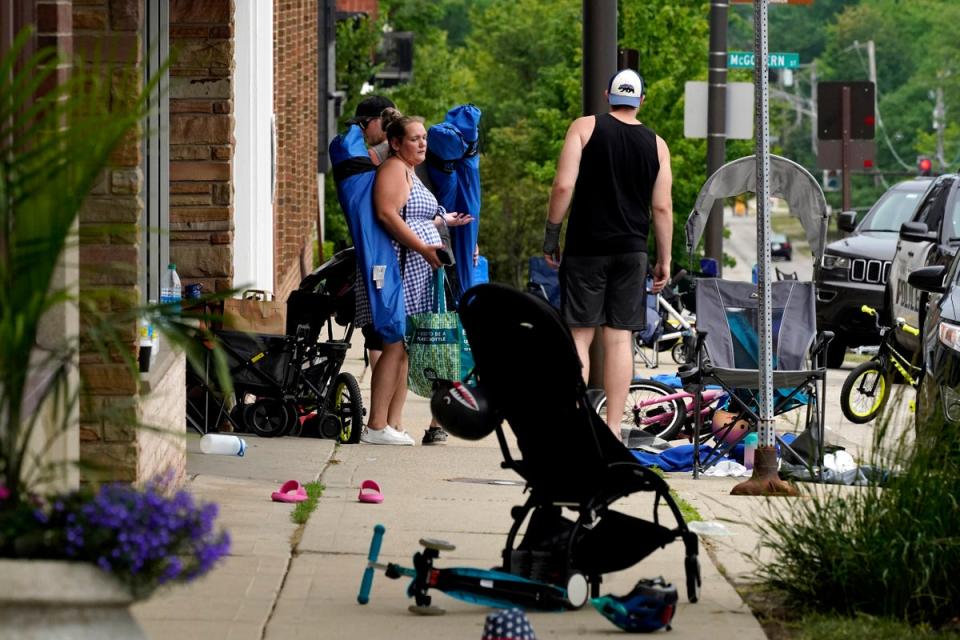 People return to their belongings in the aftermath of the shooting (Copyright 2022 The Associated Press. All rights reserved.)