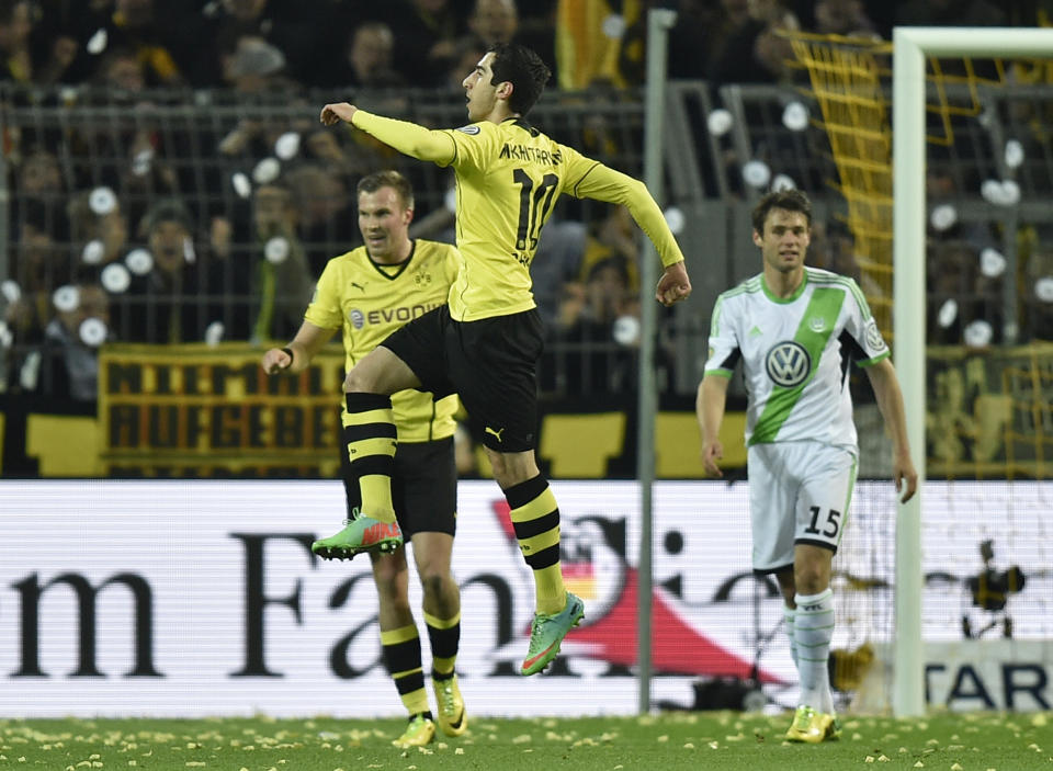 Dortmund's Henrikh Mkhitaryan of Armenia, center, jumps to celebrate his opening goal during the semifinal match of the German soccer cup between Borussia Dortmund and VfL Wolfsburg in Dortmund , Germany, Tuesday, April 15, 2014. (AP Photo/Martin Meissner)