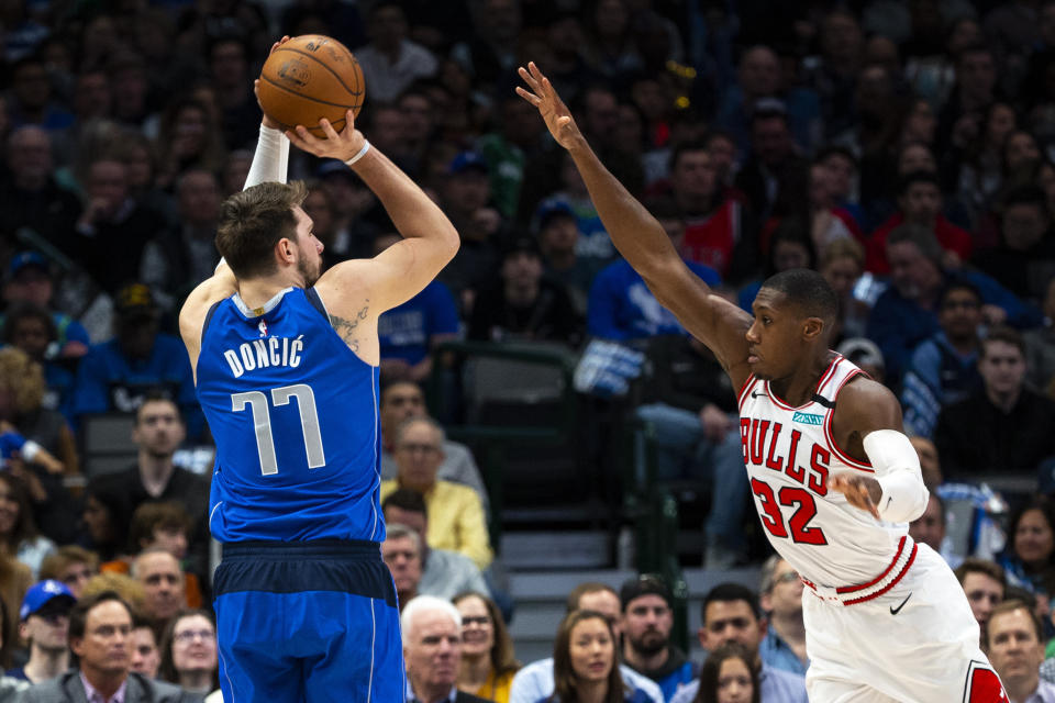 Dallas Mavericks forward Luka Doncic (77) attempts to shoot as Chicago Bulls guard Kris Dunn (32) defends during the first half of an NBA basketball game, Monday, Jan. 6, 2020, in Dallas. (AP Photo/Sam Hodde)