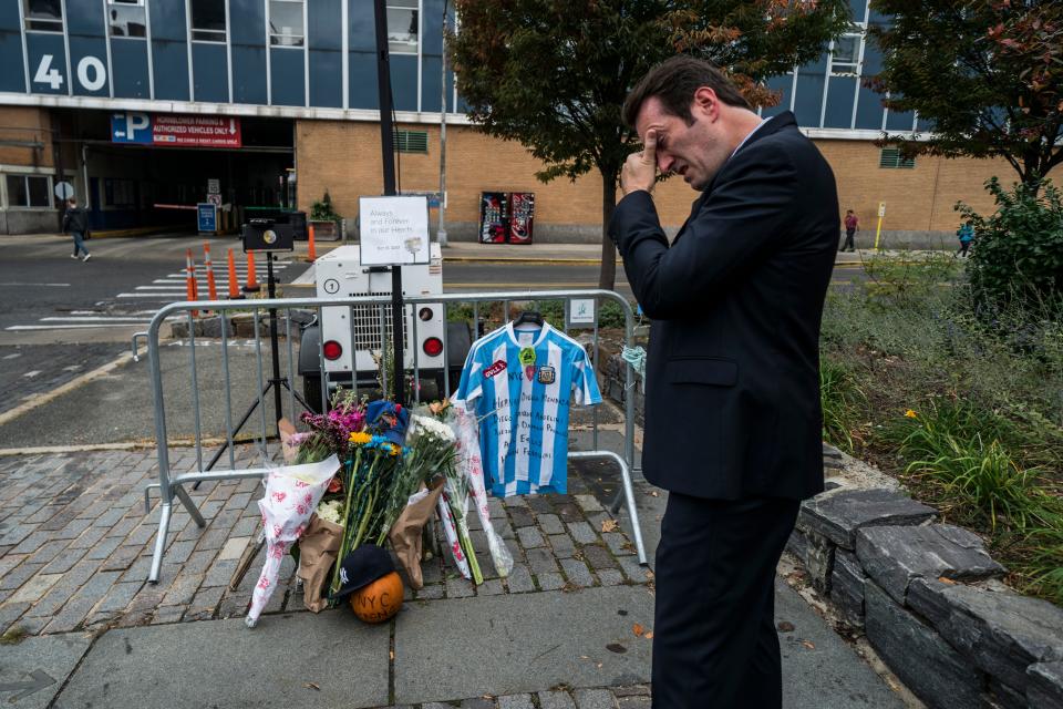 <p>A local resident reacts after placing an Argentinian soccer jersey at a makeshift memorial for the October 31 terror attack victims along a bike path in New York City, on Nov. 2, 2017. (Photo: Jewel Samad/AFP/Getty Images) </p>