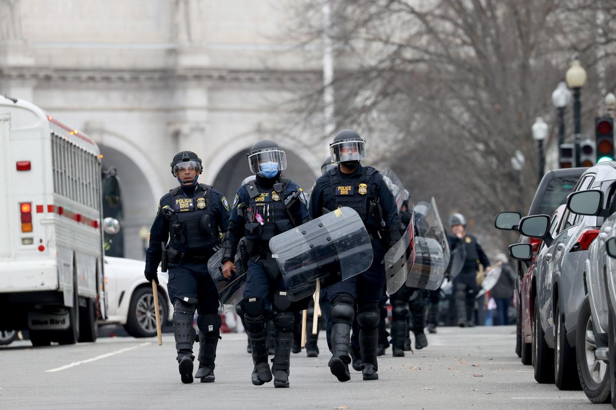 Police officers in riot gear walk towards the U.S. Capitol as protesters enter the building on January 06, 2021 in Washington, DC. Trump supporters gathered in the nation's capital today to protest the ratification of President-elect Joe Biden's Electoral College victory over President Trump in the 2020 election.