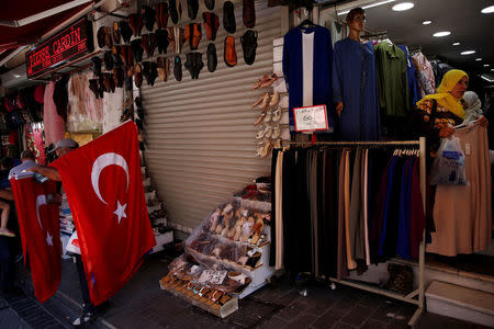 Women shop for clothes at Mahmutpasa street, a popular middle-class shopping district, in Istanbul, Turkey August 10, 2018. REUTERS/Murad Sezer
