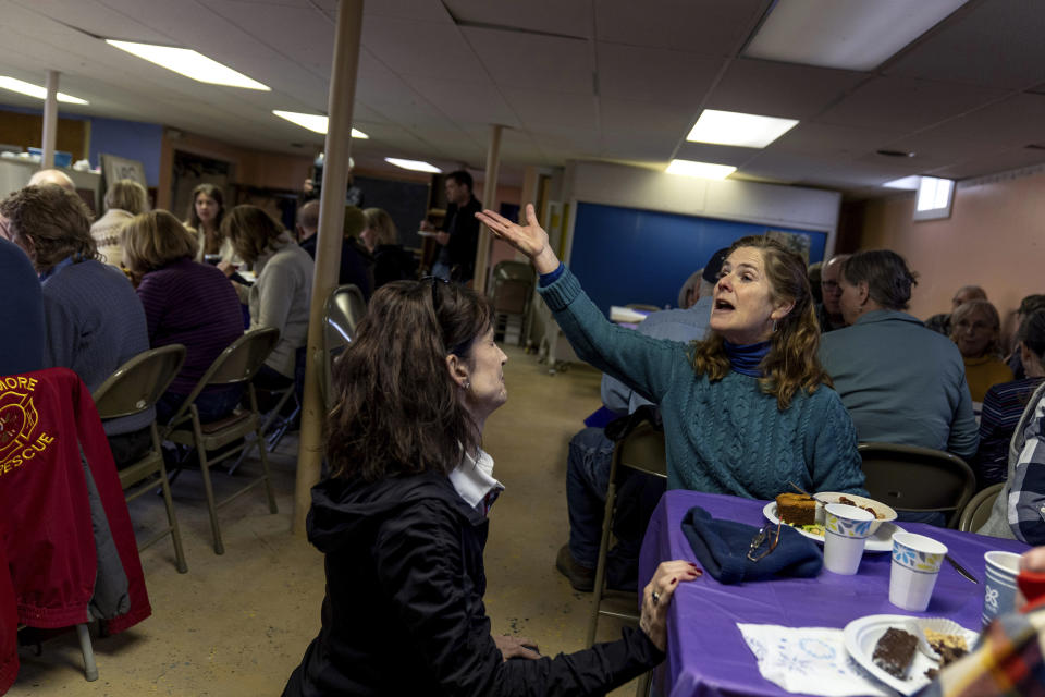 Faith Boudreau, right, talks with Caroline DeVore, selectboard chairperson, left, during a pot luck luncheon following the annual Town Meeting, Tuesday, March 5, 2024, in Elmore, Vt. After nearly four hours, Town Meeting adjoins and residents of all political background sit down for lunch at the United Methodist church across the street. (AP Photo/David Goldman)