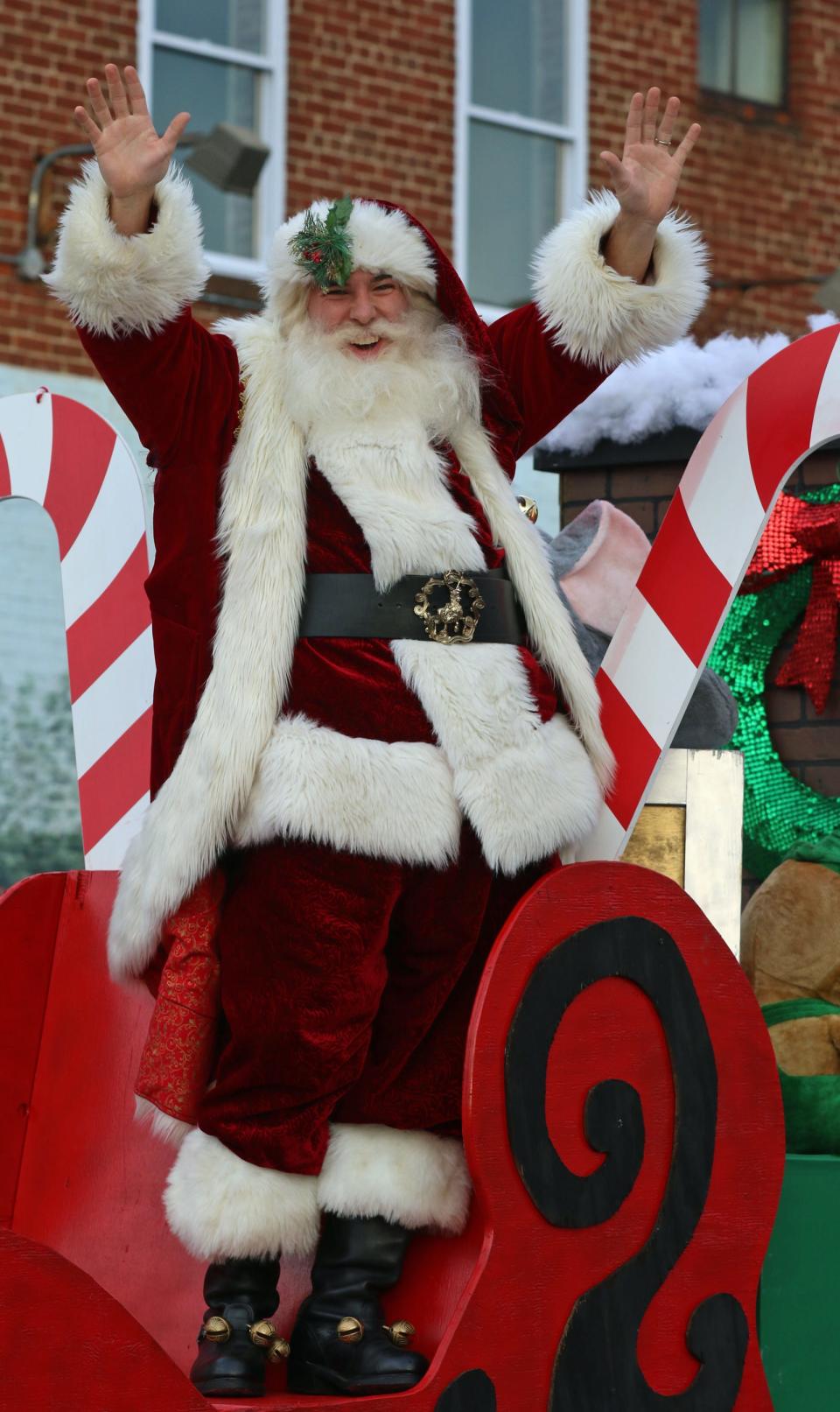 Santa waves from his float as hundreds of people lined the streets as the annual Kings Mountain Christmas Parade made its way along South Battleground Avenue Saturday afternoon, Dec. 4, 2021.