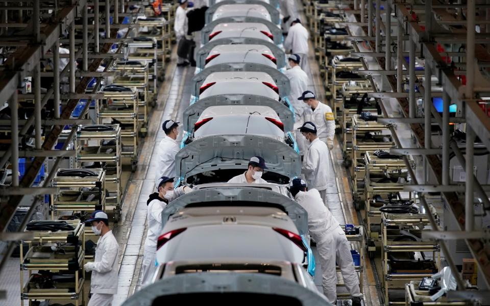 Employees work on a production line inside the Honda factory in Wuhan - REUTERS/Aly Song