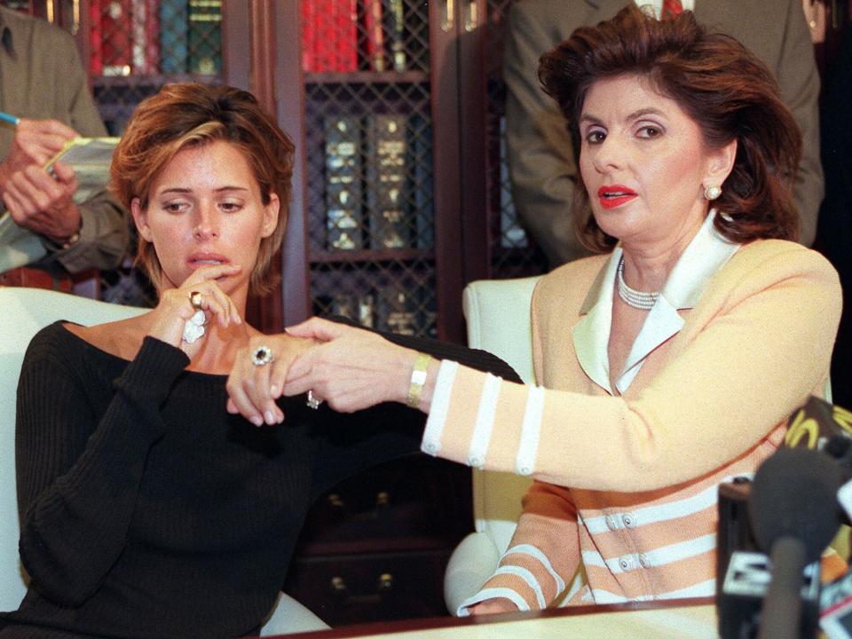 Kelly Fisher, 31, (L) and her attorney Gloria Allred show off the large sapphire and diamond engagement ring given to her by former Egyptian fiancee Dodi al-Fayed