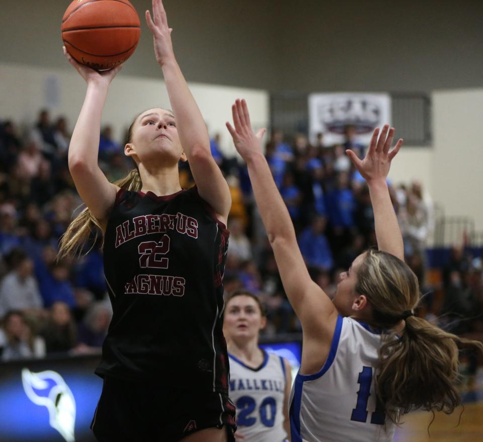 Albertus Magnus' Julia Scott attempts a shot over Wallkill's Zoe Mesuch during the New York State Class AA regional girls basketball final on March 8, 2024.