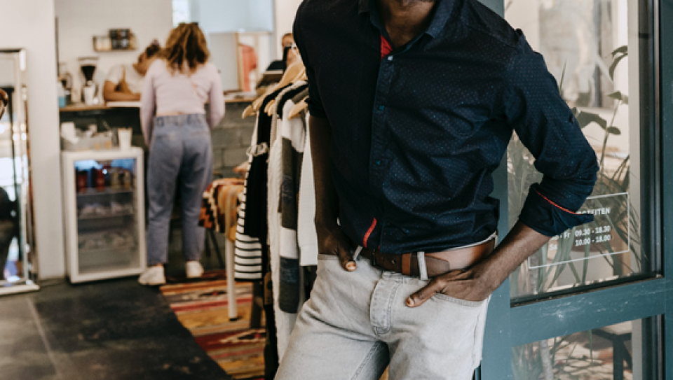 A man in a store with his hands in his pockets.