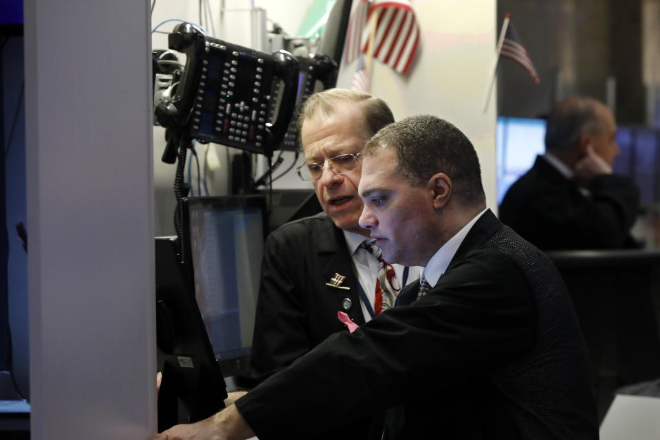 A pair of traders confer on the floor of the New York Stock Exchange, Thursday, Jan. 9, 2020. Stocks are opening broadly higher on Wall Street as traders welcome news that China's top trade official will head to Washington next week to sign a preliminary trade deal with the U.S. (AP Photo/Richard Drew)