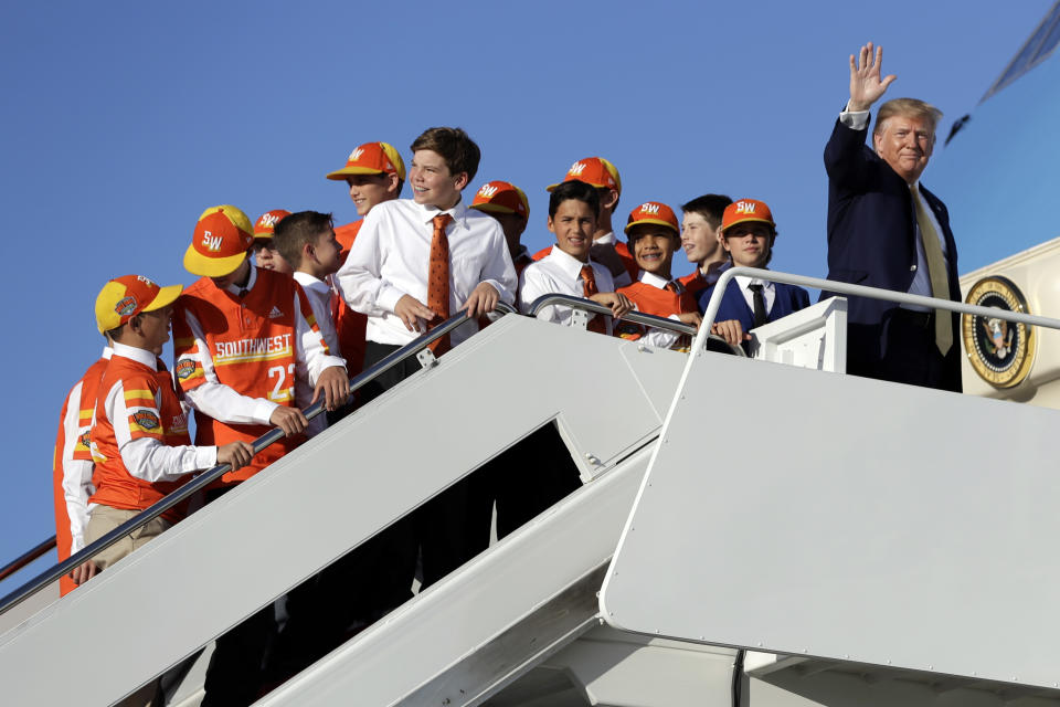 President Donald Trump boards Air Force One with Louisiana's Eastbank Little League team who won the 2019 Little League Baseball World Series Friday, Oct. 11, 2019, in Andrews Air Force Base, Md. Trump was heading to a campaign rally in Lake Charles, La. (AP Photo/Evan Vucci)
