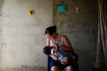 Emileidy Ojeda, 26, breastfeeds her four-month-old son David, ahead of her sterilization surgery, at their house in San Francisco de Yare, Venezuela July 11, 2016. REUTERS/Carlos Garcia Rawlins