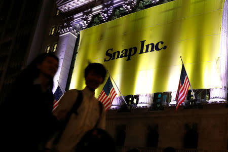 A Banner for Snap Inc. hangs on the facade of the the New York Stock Exchange (NYSE) on the eve of the company's IPO in New York, U.S., March 1, 2017. REUTERS/Brendan McDermid