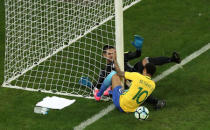 Football Soccer - Brazil v Paraguay - World Cup 2018 Qualifiers - Arena Corinthians stadium, Sao Paulo, Brazil - 28/3/17 - Paraguay's goalkeeper Antony Silva tries to stop Brazil's Neymar (10). REUTERS/Paulo Whitaker