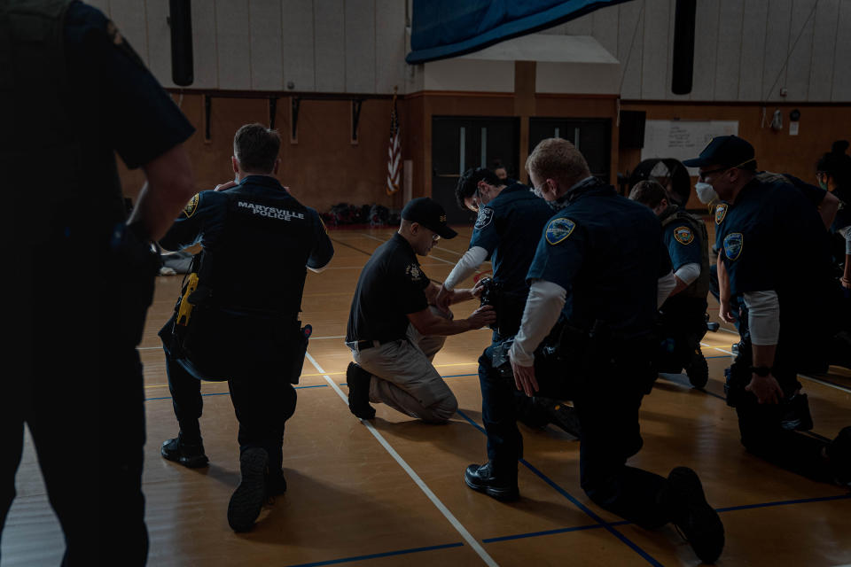 Police recruits practice holstering a taser at an introductory taser class.<span class="copyright">Jovelle Tamayo for TIME</span>