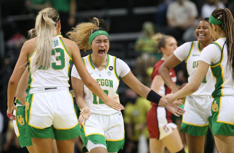 Oregon's Te-Hina Paopao, center, celebrates with teammates during a timeout in the fourth quarter against Stanford Feb. 20, 2022. 