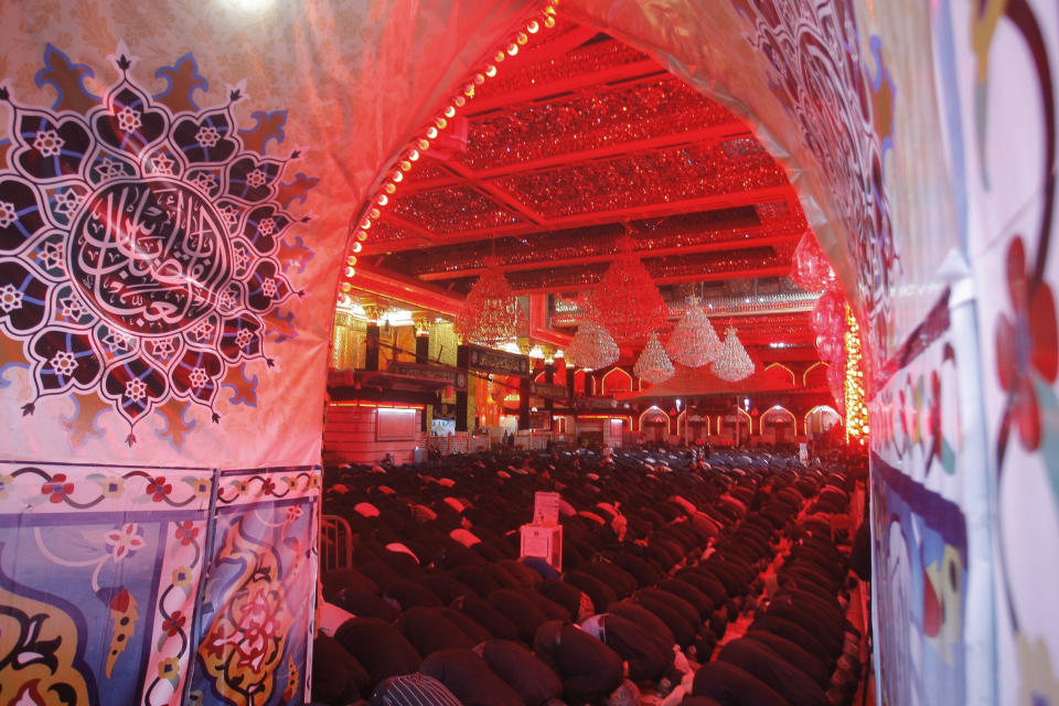 FILE - In this Sept. 10, 2019, file photo, Shiite Muslim worshippers pray inside the shrine of Imam Abbas on the holy day of Ashoura, in Karbala, Iraq. Shiites mark Ashoura, the 10th day of the month of Muharram, to commemorate the Battle of Karbala, in which Imam Hussein, a grandson of Prophet Muhammad, was killed. Ordinarily Ashoura is marked with public celebrations around the world. But with the pandemic sweeping the globe and cases rising in Iraq, the country's top Shiite cleric, Grand Ayatollah Ali al-Sistani, encouraged people to observe the day in other ways such as watching online or televised commemorations from home. (AP Photo/Anmar Khalil, File)