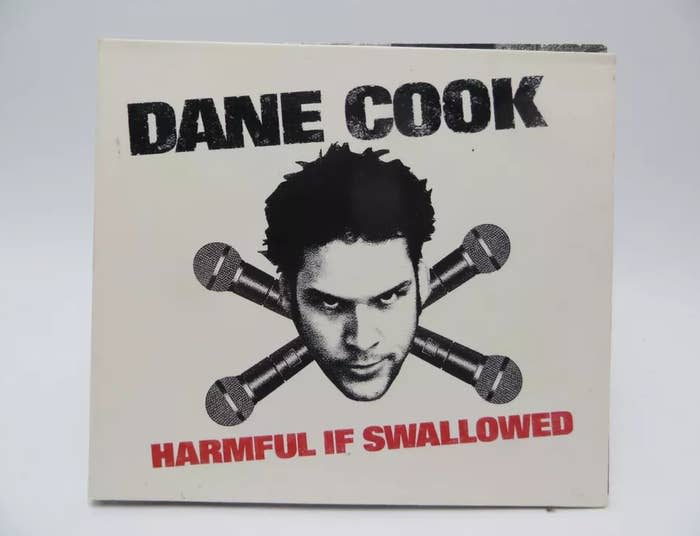 Album cover of Dane Cook 'Harmful If Swallowed' with his face centered and microphones crossed below