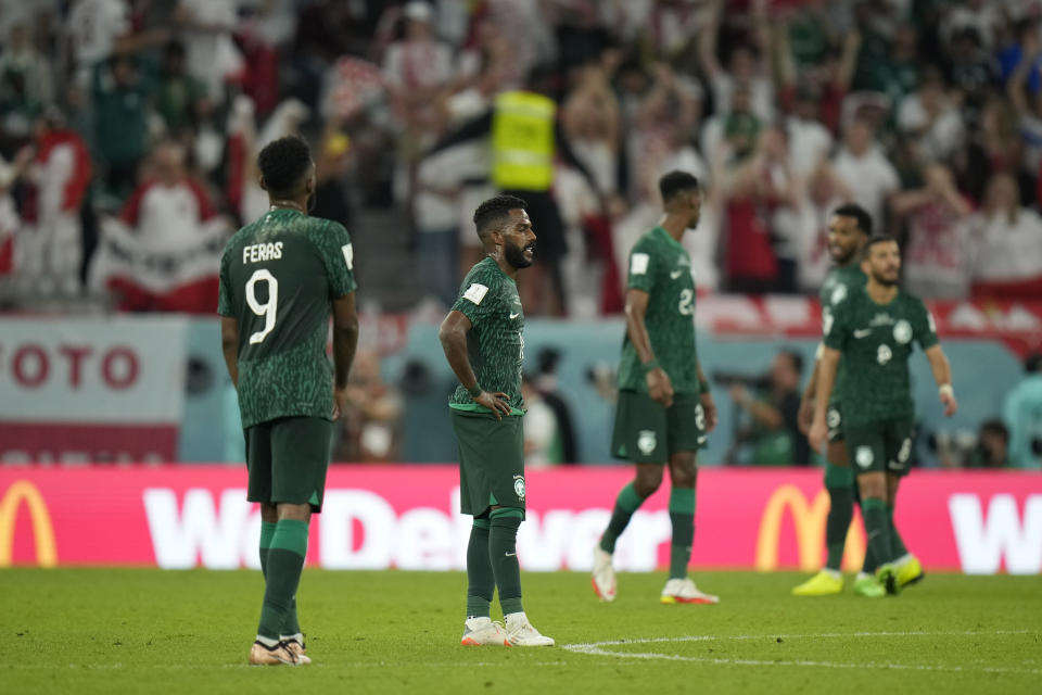 Saudi Arabia players react after Poland's Robert Lewandowski scored his side's second goal during the World Cup group C soccer match between Poland and Saudi Arabia, at the Education City Stadium in Al Rayyan , Qatar, Saturday, Nov. 26, 2022. (AP Photo/Francisco Seco)