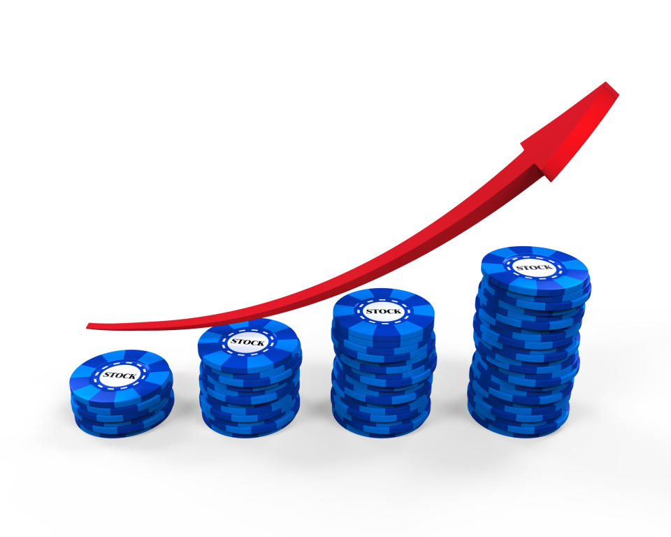 Four increasingly higher stacks of blue chips with a red line trending upwards.