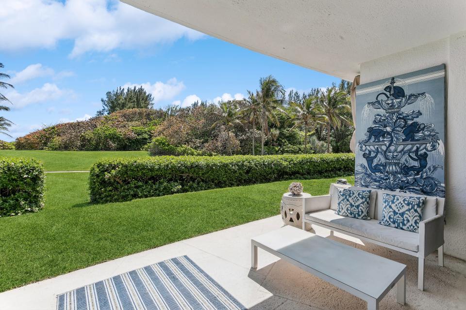 From the main patio, a break in the hedge leads to a lawn fronting the beach.