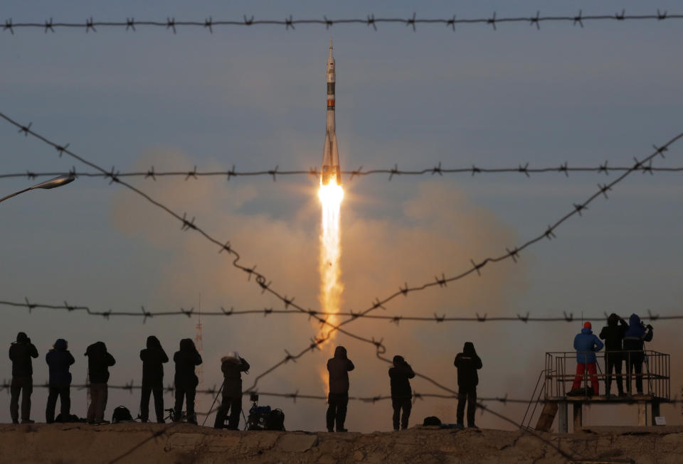 FILE - In this Monday, Dec. 3, 2018 file photo the Soyuz-FG rocket booster with Soyuz MS-11 space ship carrying a new crew to the International Space Station, ISS, blasts off at the Russian leased Baikonur cosmodrome, Kazakhstan. The Russian rocket carries U.S. astronaut Anne McClain, Russian cosmonaut Oleg Kononenko‚Äé and CSA astronaut David Saint Jacques. (AP Photo/Dmitri Lovetsky, File)