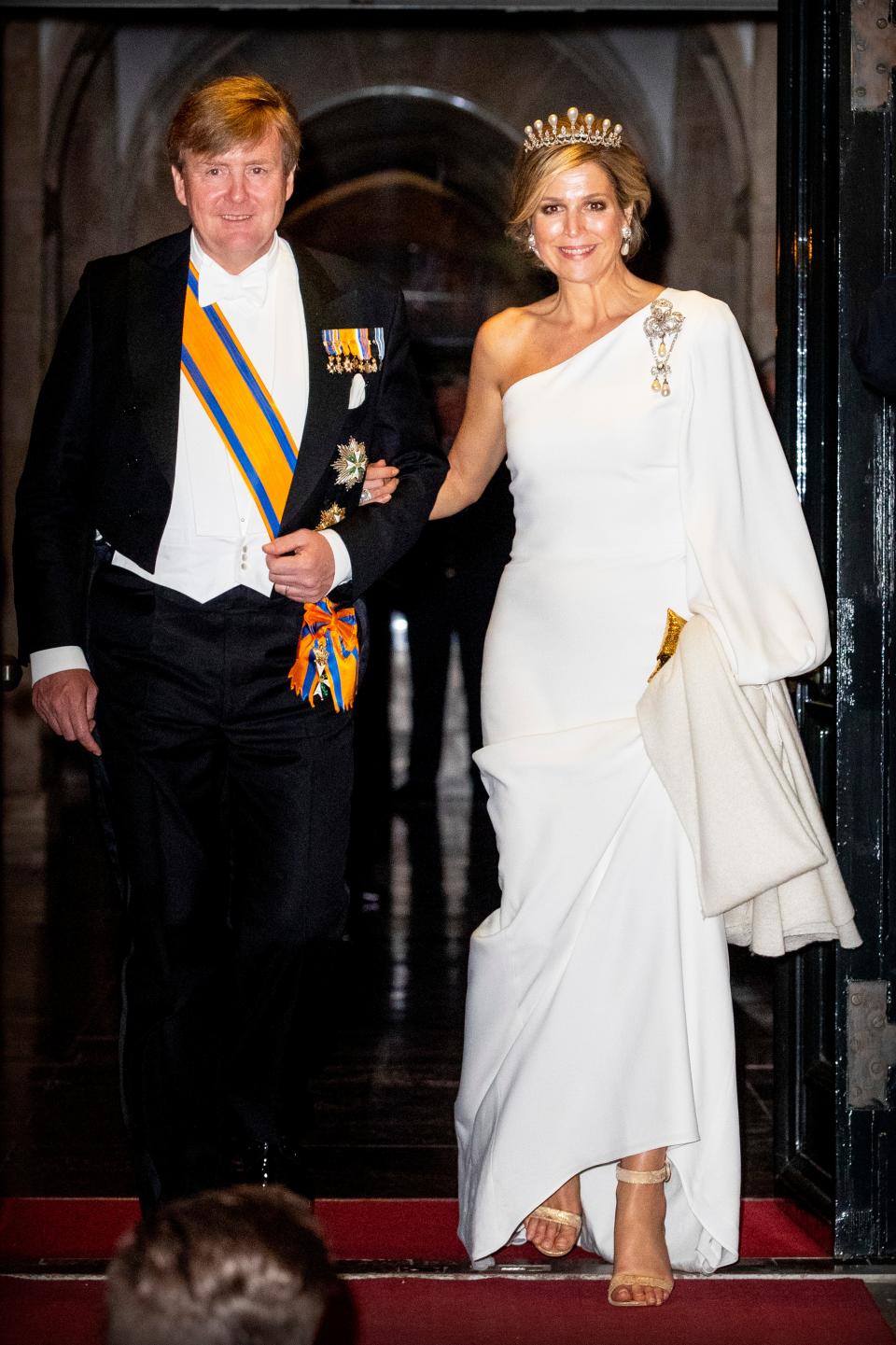 King Willem-Alexander of The Netherlands with Queen Maxima of The Netherlands, wearing a white one-shoulder dress