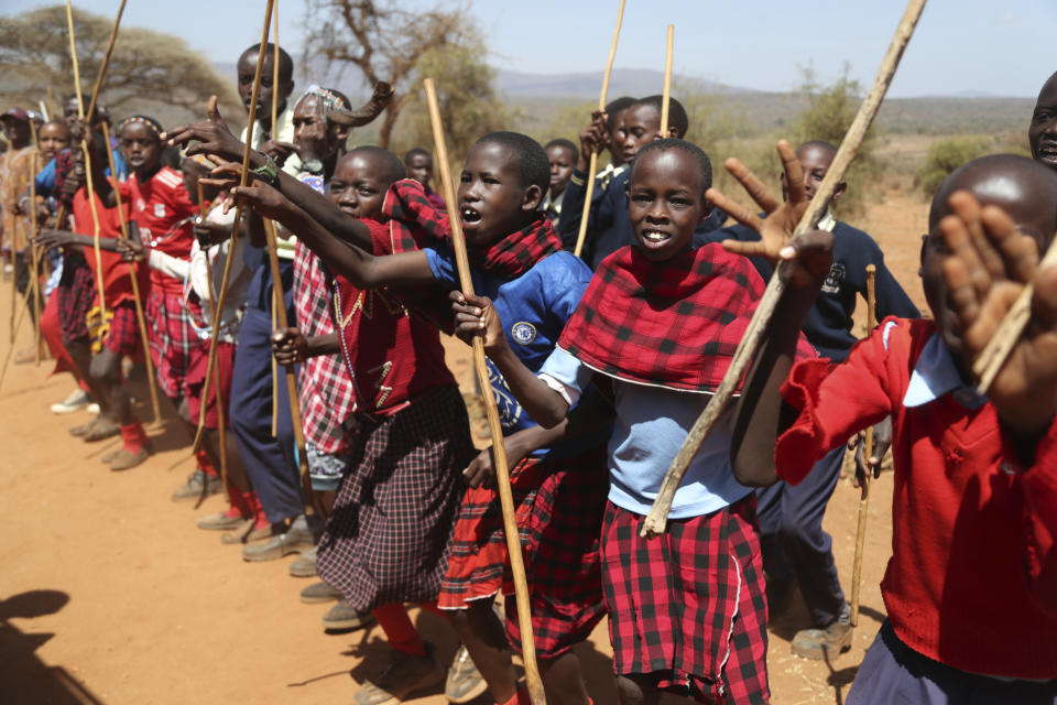 Maasai children line up to greet US first Lady Jill Biden and US Ambassador to Kenya Meg Whitman during their visit to Ngatataek, Kajiado Central, Kenya, Sunday, Feb. 26, 2023. Biden traveled on Sunday to an area near Kenya's border with Tanzania to raise awareness about a severe drought that is endangering lives and livelihoods.(AP Photo/Brian Inganga)