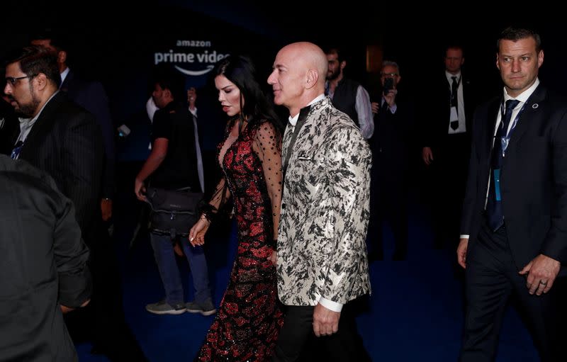 FILE PHOTO: Jeff Bezos, founder of Amazon, and his girlfriend TV presenter Lauren Sanchez arrive at a company event in Mumbai