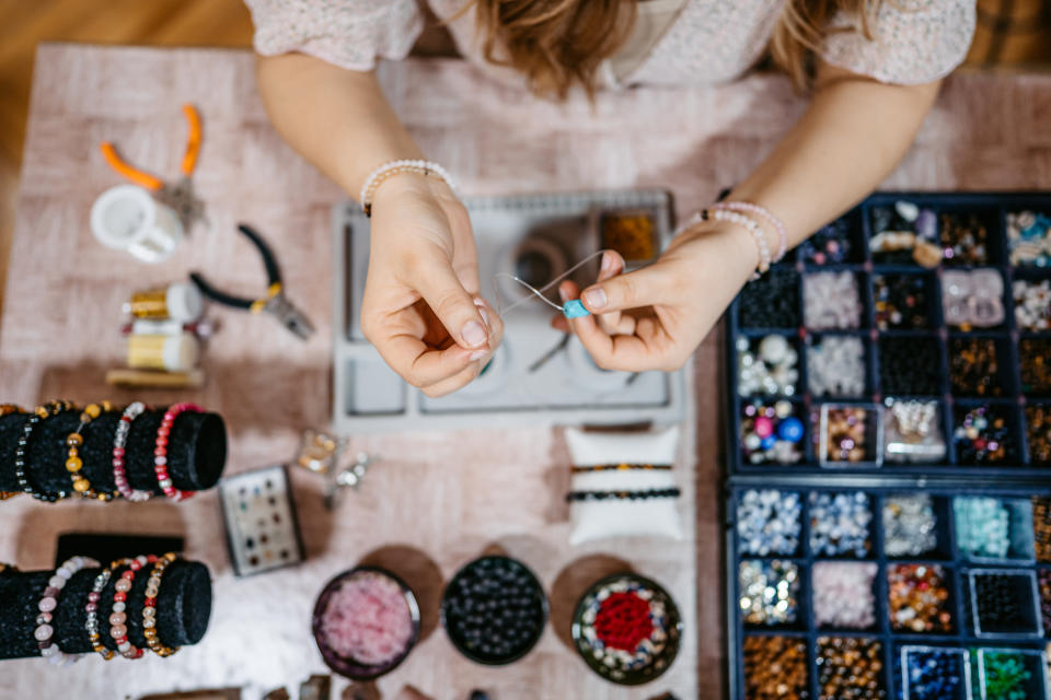 hands making jewelry