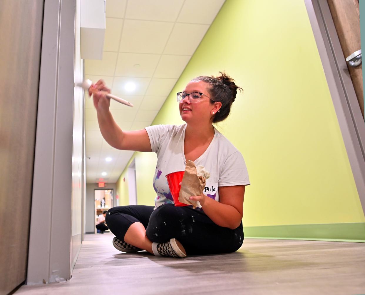 WORCESTER - UMass Chan Medical School employee Margarita Clarke of Auburn helps paint a hallway during the United Way of Central Massachusetts 30th Annual Day of Caring on Friday. 