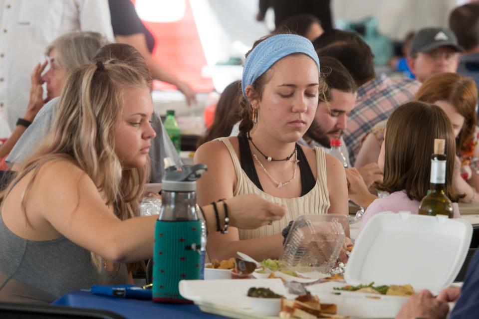 Visitors sample Greek cuisine during the 2019 Greek Festival of Pensacola at Annunciation Greek Orthodox Church. The church will not host an in-person festival this year but residents can purchase some of the festival's favorites via pre-order.