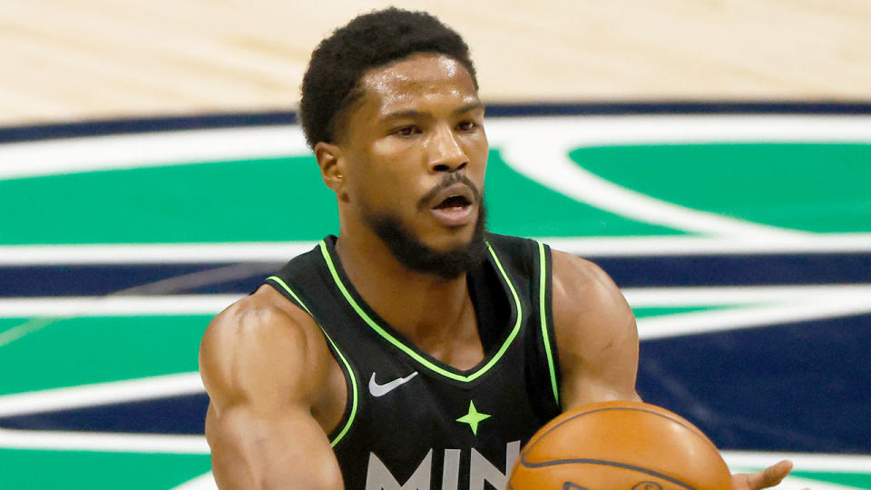 Pictured here, Malik Beasley passes the basketball during a match for the Minnesota Timberwolves.