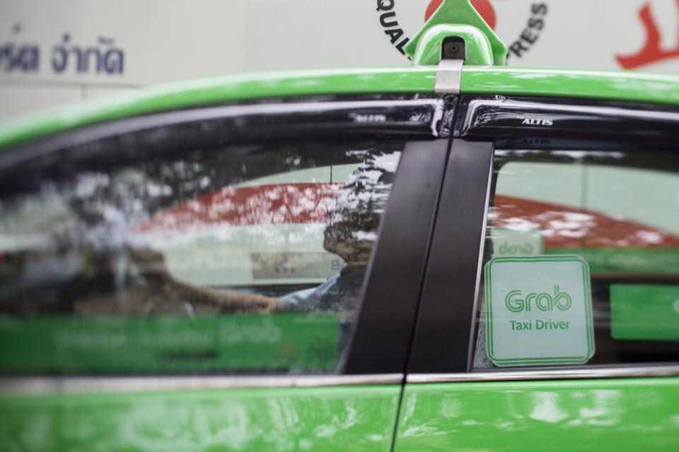 The Grab logo is displayed on a taxi in Bangkok, Thailand, on Friday, March 9, 2018. Grab, (Brent Lewin/Bloomberg)