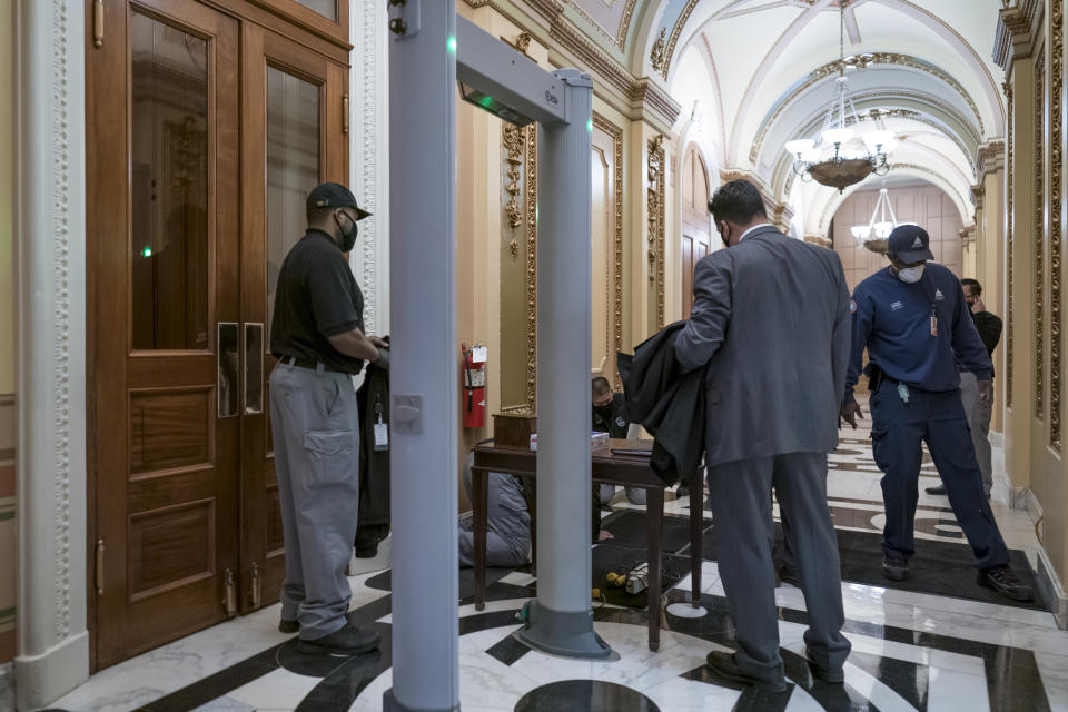 Metal detectors for lawmakers are installed in the corridor around the House of Representatives chamber after a mob loyal to President Donald Trump stormed the Capitol last week, in Washington, Tuesday, Jan. 12, 2021. (AP Photo/J. Scott Applewhite)